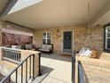 Inviting covered porch with comfortable seating, a porch swing, and a welcoming front door at 318 E Iowa Ave, Berthoud, CO 80513