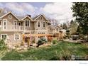 Beautiful backyard with a patio, pergola, mature trees, and professional landscaping at 3189 5Th St, Boulder, CO 80304