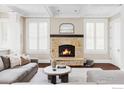 Cozy living room with a stone fireplace, coffered ceilings, and large windows at 3189 5Th St, Boulder, CO 80304