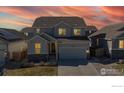 Home exterior displaying a charming facade, complemented by a vivid sunset background at 3196 Park St, Mead, CO 80542