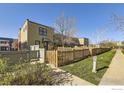Well-manicured front yard with a wooden fence surrounding a modern home exterior at 3215 Foundry Pl # 106N, Boulder, CO 80301