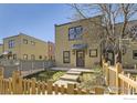 Attractive home exterior featuring a well-maintained lawn and charming wooden fence at 3215 Foundry Pl # 106N, Boulder, CO 80301