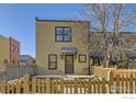 Charming home exterior with a quaint wooden fence and well-kept front yard at 3215 Foundry Pl # 106N, Boulder, CO 80301