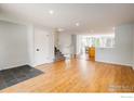 Spacious living room with hardwood floors and open access to the kitchen and staircase at 322 W Harper St, Louisville, CO 80027