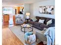 Comfortable living room featuring modern decor, hardwood floors, and an open floor plan at 322 W Harper St, Louisville, CO 80027