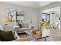 Inviting living room with a large window, comfortable seating, and a view of the outdoors at 3770 Iris Ave # B, Boulder, CO 80301