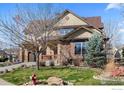 Attractive two-story home with stone accents, manicured lawn, and mature trees enhancing curb appeal at 4236 Frederick Cir, Longmont, CO 80503