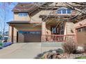 Beautiful home featuring a welcoming front porch, stone accents, and a spacious driveway with three-car garage at 4236 Frederick Cir, Longmont, CO 80503