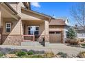Lovely home showcasing a cozy front porch with stone pillars and landscaped yard at 4236 Frederick Cir, Longmont, CO 80503