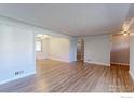 Open-concept living room with hardwood floors and neutral color palette at 4580 Balsam St, Wheat Ridge, CO 80033