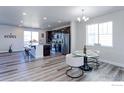 Bright and open-concept kitchen featuring sleek stainless steel appliances, a large island, and modern finishes throughout at 4783 S Wenatchee Cir, Aurora, CO 80015
