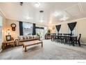 Open concept living room and dining area with large windows providing ample natural light at 5335 Allison St, Arvada, CO 80002