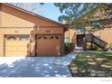 Exterior view featuring attached garages and a private entrance with stairs to a second-level unit at 6221 Willow Ln, Boulder, CO 80301
