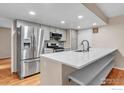 Updated kitchen with stainless steel appliances and a large center island at 6221 Willow Ln, Boulder, CO 80301