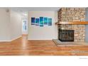 Spacious living room with hardwood floors and stone fireplace at 6221 Willow Ln, Boulder, CO 80301
