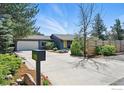 Charming home exterior with a well-maintained yard, complemented by a spacious driveway and attached garage at 700 Brooklawn Dr, Boulder, CO 80303