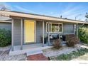 Inviting home exterior with a bright yellow door and a cozy porch at 700 Brooklawn Dr, Boulder, CO 80303