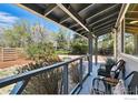 Cozy porch with comfortable seating and a view of the landscaped yard at 700 Brooklawn Dr, Boulder, CO 80303