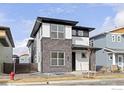 Stylish two-story home with a combination of stone and modern siding accents at 735 Discovery Pkwy, Superior, CO 80027