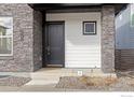 Close-up view of the home's entryway, showcasing a solid, modern front door at 735 Discovery Pkwy, Superior, CO 80027