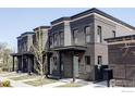Side-angle view of modern townhomes with dark brick, showcasing the architectural details at 859 30Th St, Denver, CO 80205