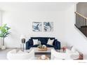 Bright living room with stylish seating, modern decor, and staircase at 859 30Th St, Denver, CO 80205