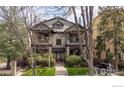 Stately brick home with a manicured front lawn, mature trees and covered front porch at 930 N Humboldt St # 4, Denver, CO 80218