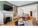 Inviting living room featuring a fireplace, ladder bookshelf, and open access to the dining area at 930 N Humboldt St # 4, Denver, CO 80218