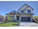 Beautiful two-story home with stone accents, a well-manicured lawn, and a spacious garage at 1041 Turnberry Cir, Louisville, CO 80027