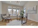 Inviting home office features hardwood floors, a neutral color palette, and backyard views at 1041 Turnberry Cir, Louisville, CO 80027