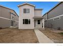 Charming two-story home with gray siding and a welcoming front porch sits on a sunny lot at 1043 Spartan Ave, Berthoud, CO 80513