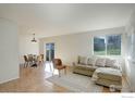 Bright living room with a neutral sofa adjacent to a dining area with views to the outside at 1120 Monroe Dr # A, Boulder, CO 80303