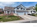 Charming two-story home featuring a well-maintained lawn, a three-car garage, and inviting curb appeal at 1441 Auburn Ct, Longmont, CO 80503
