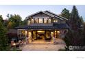 Charming back patio featuring a dining area, fire pit, and seamless access to indoor living spaces at 1525 Jennine Pl, Boulder, CO 80304