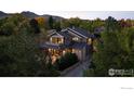 Beautiful exterior shot of home surrounded by lush trees and landscaping at 1525 Jennine Pl, Boulder, CO 80304