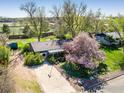 Aerial view of a well-maintained home with mature trees and green lawn at 1542 Kilkenny St, Boulder, CO 80303