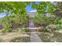 Landscaped front yard with a stone walkway leading to the charming home entrance at 1557 North St, Boulder, CO 80304