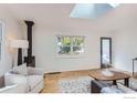 Cozy living room with hardwood floors, natural light, and a modern fireplace at 1557 North St, Boulder, CO 80304
