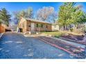 Inviting brick home with a long driveway and a well-kept yard, showcasing curb appeal at 1709 9Th Ave, Longmont, CO 80501