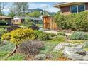 Charming front yard featuring mature landscaping and a glimpse of the nearby mountains at 195 S 35Th St, Boulder, CO 80305
