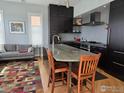Modern kitchen with dark cabinets, stone countertops, stainless steel appliances and an open layout at 2336 Spruce St # 5, Boulder, CO 80302