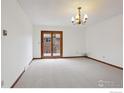 Bright living room features neutral carpet, fresh paint, and glass doors to the outside at 2651 9Th St, Boulder, CO 80304