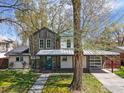 Inviting home featuring a covered porch, a blend of siding materials, mature trees, and a well-manicured front yard at 2970 21St St, Boulder, CO 80304