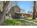 Charming home with a covered porch, mixed siding, blue door and well-kept landscaping at 2970 21St St, Boulder, CO 80304