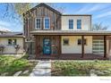 Charming home showcasing a modern porch with wooden accents, a bright blue door, and a well-maintained yard at 2970 21St St, Boulder, CO 80304
