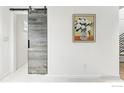 Hallway with a modern sliding barn door and decorative painting at 2970 21St St, Boulder, CO 80304