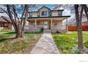 Charming two-story home with a large front porch perfect for relaxing at 313 E Iowa Ave, Berthoud, CO 80513