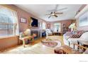 Cozy living room featuring a fireplace, hardwood floors, and lots of natural light at 313 E Iowa Ave, Berthoud, CO 80513