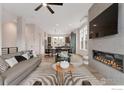 Open-concept living room with fireplace and a view into the adjacent kitchen and dining area at 352 Superior Dr, Superior, CO 80027
