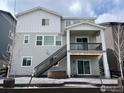 Spacious backyard with a concrete patio, outdoor staircase, and mature trees at 3672 Outcrop Ct, Castle Rock, CO 80108